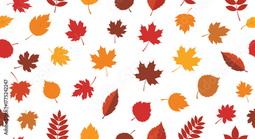 Seamless pattern of colorful autumn leaves scattered on a white background.