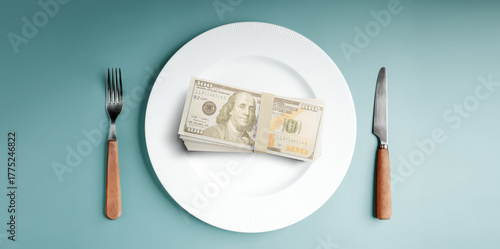 Money served on a plate with cutlery symbolizes capitalism. Table Top View