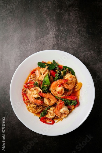 Stir fried spicy shrimp in a white plate