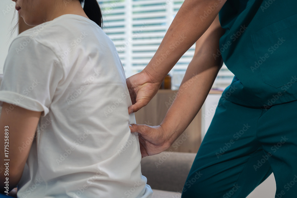 Fototapeta premium Help of a therapist trainer during a rehabilitation session. woman doing exercise at clinic with physiotherapist.