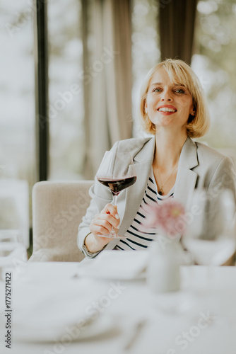 Woman enjoying red wine at ...