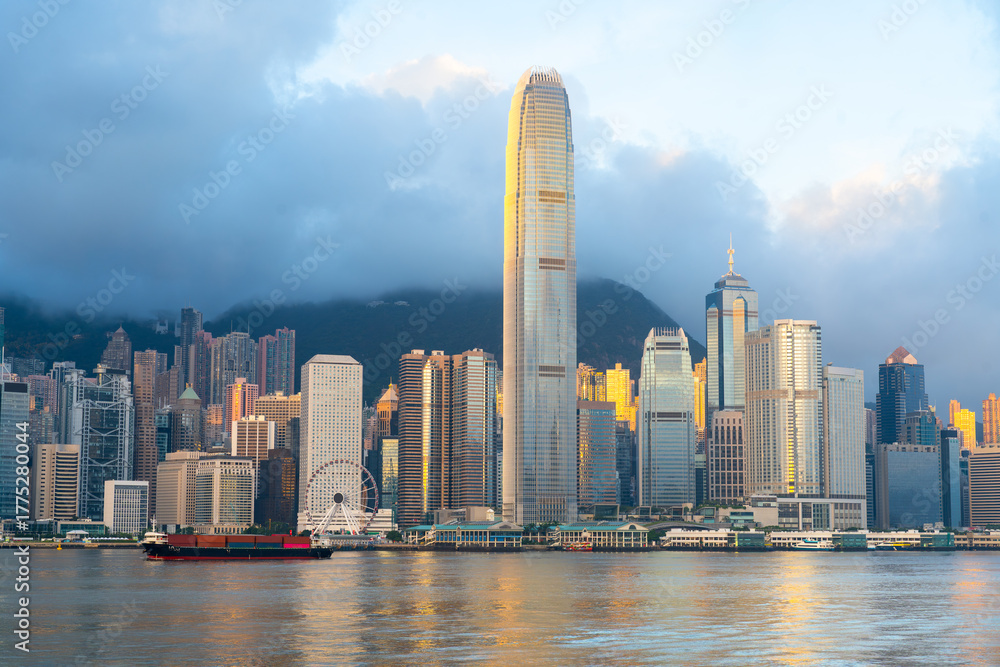 Fototapeta premium Hong Kong cityscape skyline at sunrise sky across Victoria harbor. One of the most tourist attaction in Hong Kong Island, China.
