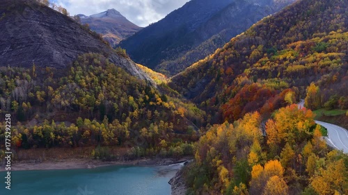 Autumn aerial landscape of French Alps with autumn forest and mountain lake, Hautes Alpes in autumn drone shot, hiking in French Alps