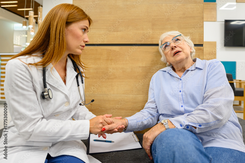 Obraz premium Female doctor consoling sad senior woman in hospital showing empathy and emotional support during medical consultation