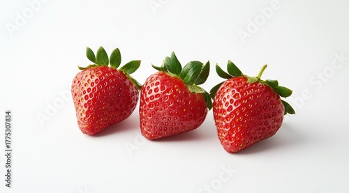 Wallpaper Mural Three fresh strawberries arranged in a row on a white surface Torontodigital.ca