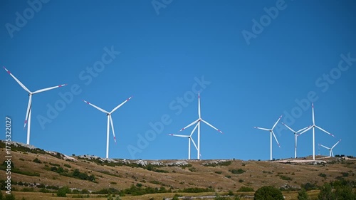 Wind turbines on a hill. Large wind farm. Electricity production. Wind power stations on mountain. 
