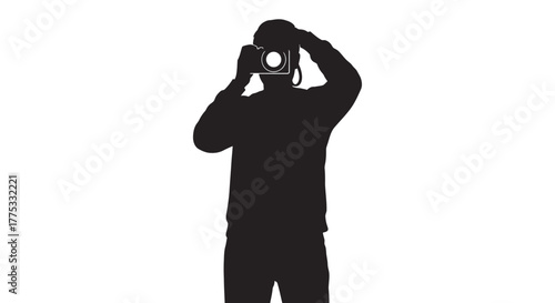 Silhouette of a person holding a camera up to their face, taking a picture.