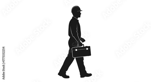 Silhouette of a man in a hard hat carrying a briefcase walking, representing a professional worker or engineer.