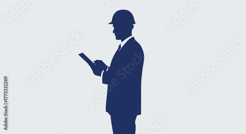Silhouette of an engineer or construction manager in a hard hat and suit, holding a tablet, representing professionalism and digital work in industry.