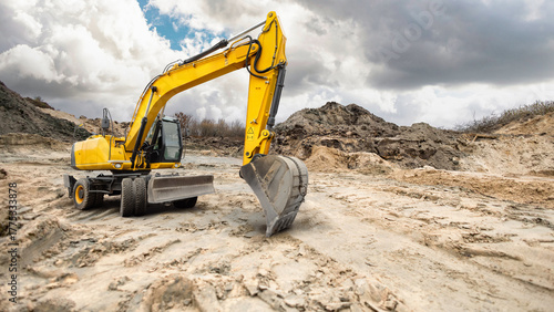 Photos A bright yellow excavator works diligently on a rugged construction site, shapin