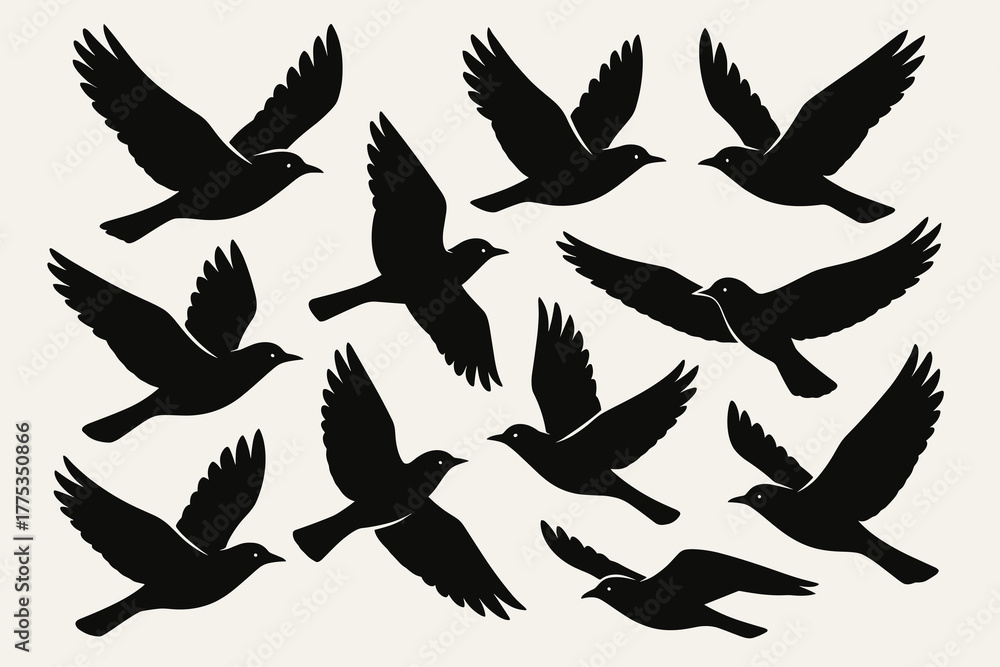 Fototapeta premium Silhouette of black birds flying in various positions on a light background