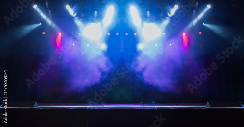 Spotlights in the concert hall. Stage light with colored spotlights and smoke.