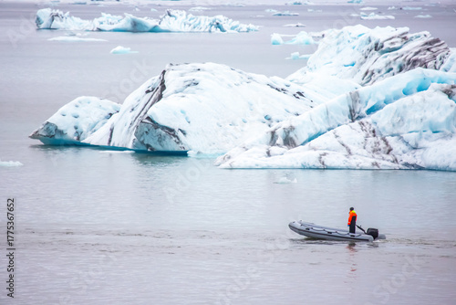 Exploring the serene waters of Iceland with a boat amidst floating icebergs