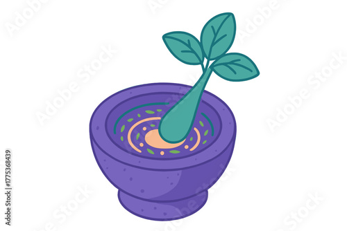 Grinding fresh green herbs and spices in a traditional stone mortar and pestle