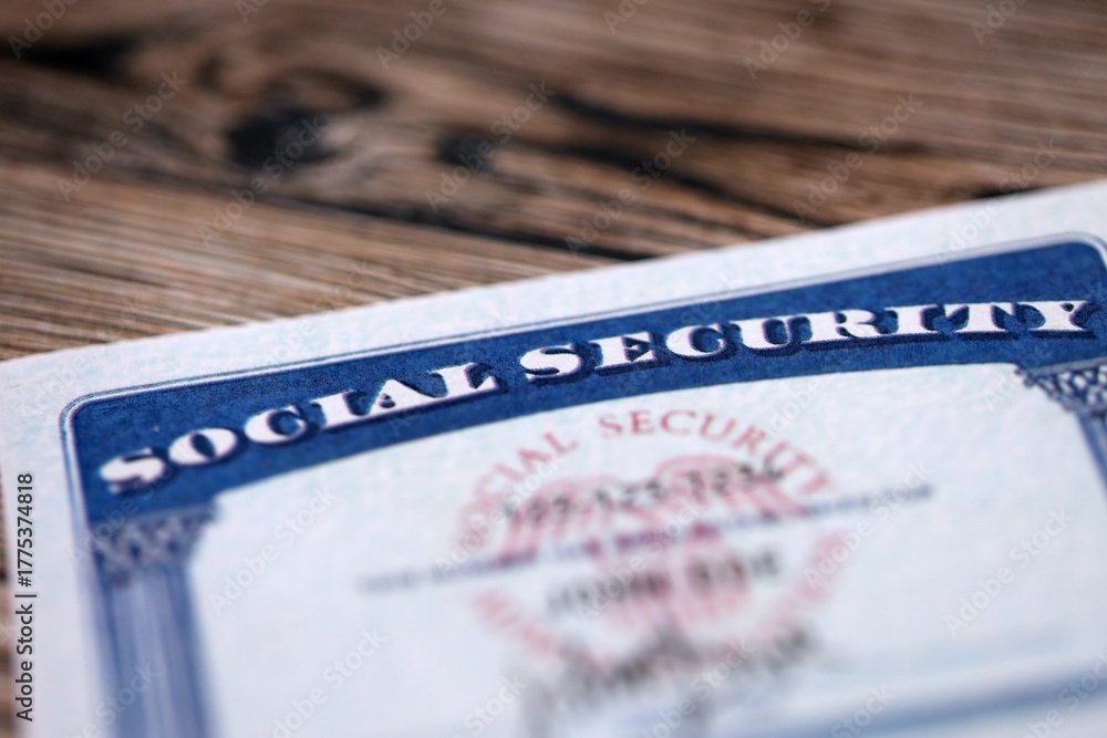 Obraz premium Social security number card on brown wooden background surface close up