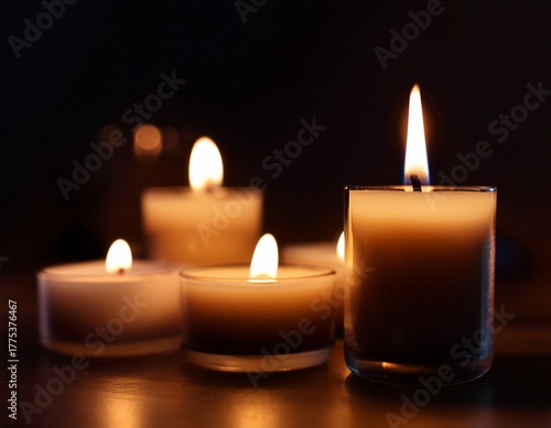 close up of scented candles burning in the dark cinematic lighting with deep shadows moody atmosphere