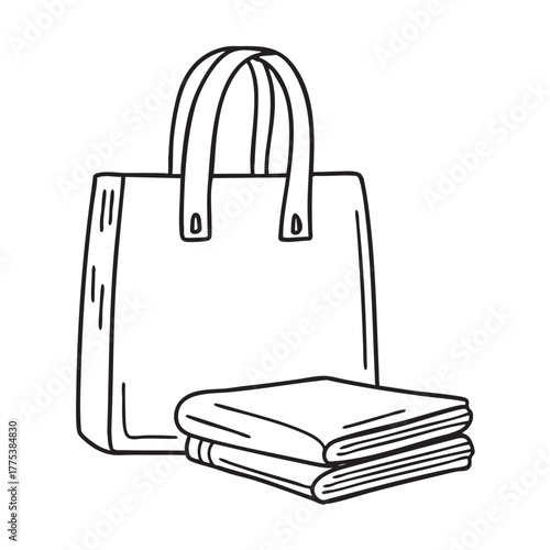 A magazine positioned beside a tote bag with folded corners