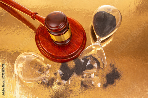 Judicial gavel and broken hourglass represent time and justice in a symbolic setting