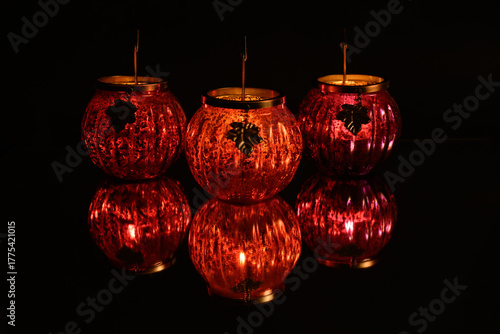 Pumpkin shaped tea light holder with reflection. 