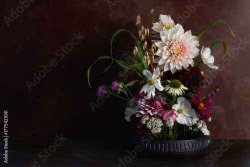Flower arrangement with Dahlias with dark background. 