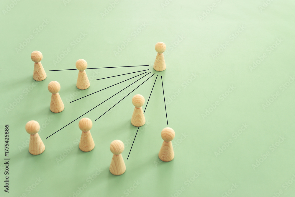 Obraz premium Wooden figures and cubes with connecting lines. Idea of collaboration and teamwork