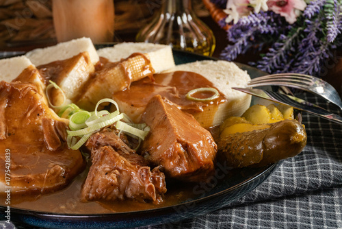 Czech dumplings with stewed pork in sauce.