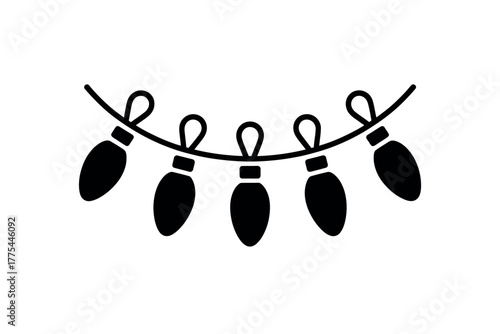 A string of festive Christmas lights illuminates a dark background