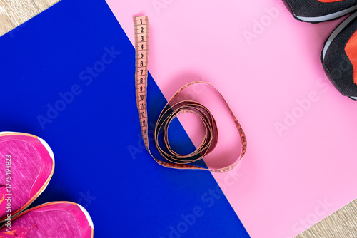 different sneakers,  colored  surface. sport shoes, Fitness accessories. Measuring tape, centimeter.