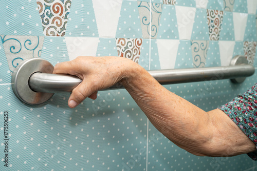 Asian elderly woman patient use toilet bathroom handle security in nursing hospital, healthy strong medical.