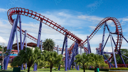 Colorful roller coaster in amusement park under bright sky, symbolizing fun, thrill, and excitement.