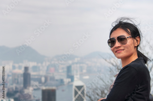 a happy chinese woman on top of victoria peak hong kong