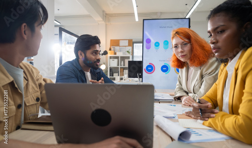 Multi-ethnic business team in office meeting, reviewing documents and brainstorming innovative ideas for a new business venture and strategy.