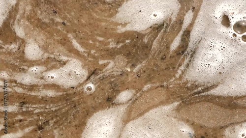 White foam from the sea waves in the whirlpool.