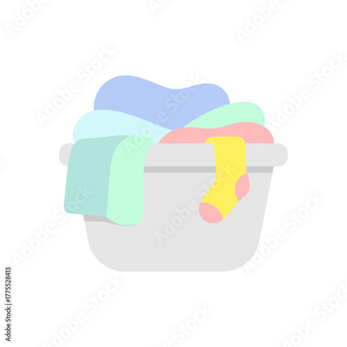 Colorful laundry basket filled with clean clothes and towels  