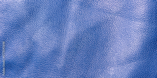 Blue genuine leather as a background macro photo. Blue background.
