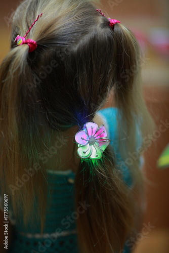 Colored purchased hairpin in a girl's hair close-up