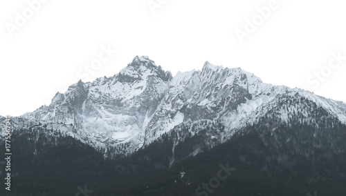 Dramatic snow-covered mountain range with sharp peaks and forested lower slopes against a png black background
