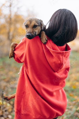 Woman Carrying Dog On her Shoulder