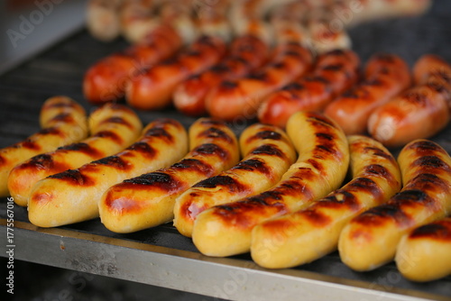 Grilling sausages on the grill with flames and smoke. food tasty sausadges, Sausage grilled to perfection on Barbeque.