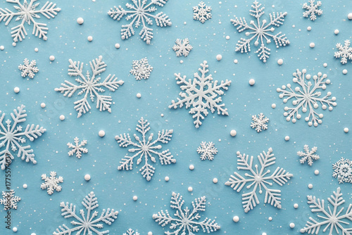 A winter background with white 3D papercraft snowflakes. This vector illustration is a cute, simple, and clean pattern, a cold, abstract holiday design.