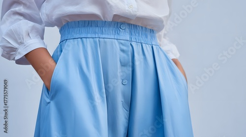 Detailed depiction of elegantly styled light blue wide-leg pants with a relaxed yet sophisticated design and a comfortable elastic waistband, ideal for upscale casual wear