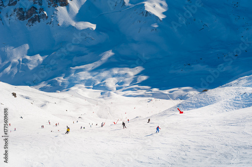Ski resort in winter Alps mountains, France. Skiers ride on the ski slope. Three valleys, Meribel, France.