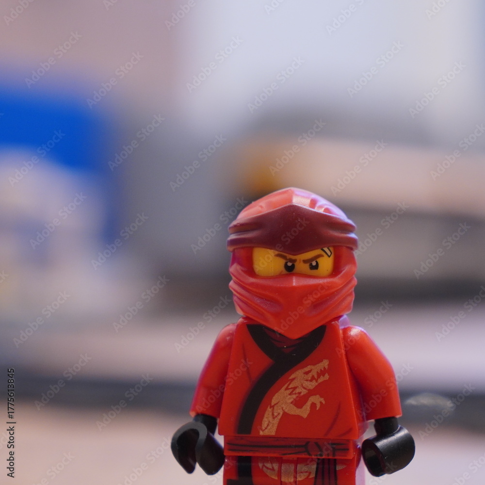 Obraz premium Red Lego Ninja Character, a Popular Children's Toy, Depicted Up Close with a Blurred Background