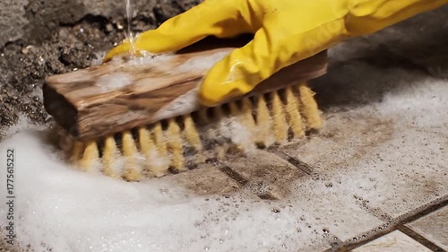 Rough textures of a scrubbing brush move vigorously back and forth together.