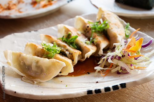 Freshly cooked Japanese dumplings, crispy gyoza with spring onion topping.