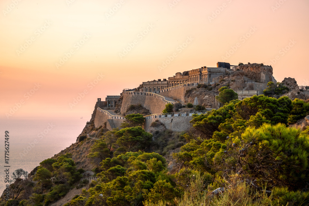 Fototapeta premium Disused military buildings on a mountain in Cabo Tiñoso in Cartagena, Region of Murcia, Spain, at dawn.