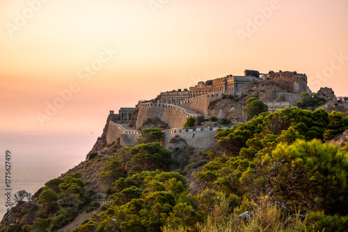 Disused military buildings on a mountain in Cabo Tiñoso in Cartagena, Region of Murcia, Spain, at dawn.