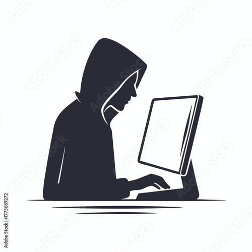 A person wearing a hood uses the computer for work or for a game