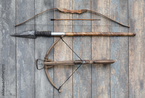 ancient wooden crossbow and bow on wooden background