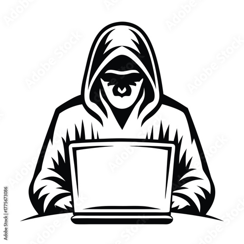 Anonymous hacker wearing a hood types on a laptop computer in stark black and white
